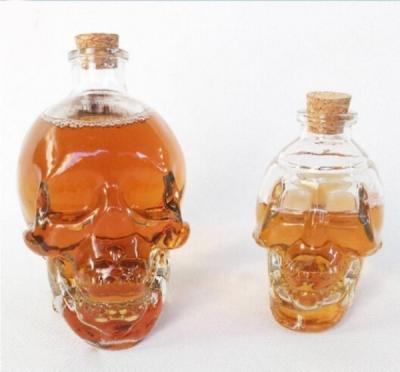 China Custom Glass Packaging Bottle Skull  Shape Glass Bottle For Liquid Storage for sale
