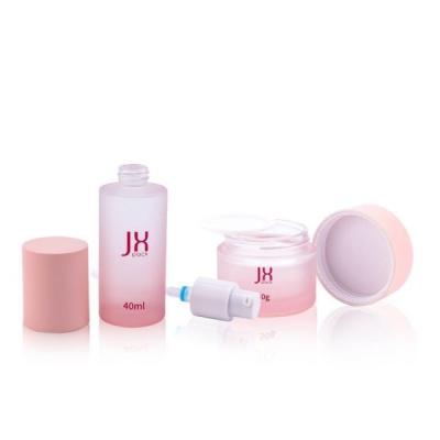 China Custom Color Cosmetic Glass Bottle Cylinder Face Cream Serum Skin Care Lotion Bottle for sale