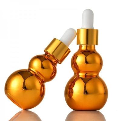 China A cabaça do ouro deu forma a cosméticos engarrafa a garrafa de vidro vazia profissional para empacotar à venda