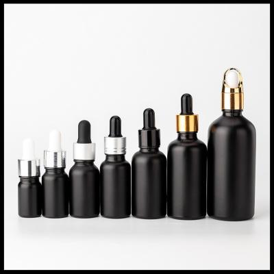 China Black Frosted Color Essential Oil Glass Bottles Cosmetic Packaging Round Shape for sale