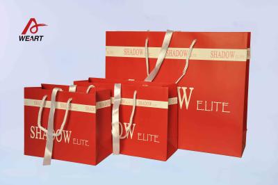 China Las bolsas de papel rojas del arte/el regalo del papel coloreado empaqueta la cinta blanca pegada agujero medio en venta