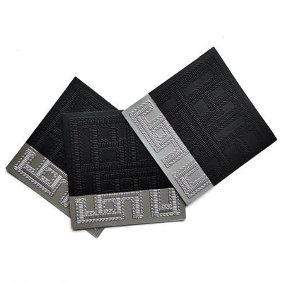 China Metal Embossed PU Leather Label Black Custom Clothes Garment Accessories for sale