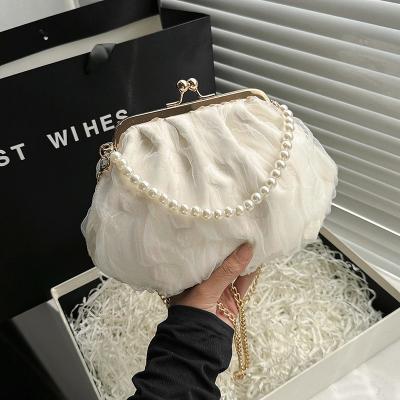 China 2024 NEW RETRO FAIRY SOLID COLOR SMALL BAG WHITE HAND PEARL BAG WOMEN'S NET YARN INS SIMPLE CROSSBODY BAG for sale