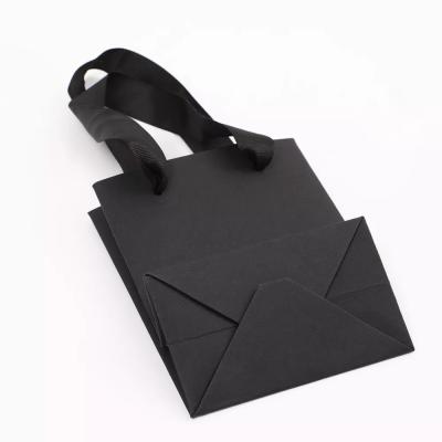 China Waterproof Oilproof Clothing Paper Bags Supermarket Black Paper Shopping Bags for sale