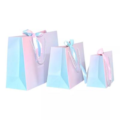 China Custom Logo Holographic Gift Paper Clothing Bags ISO Gradient Drawstring Paper Bag for sale