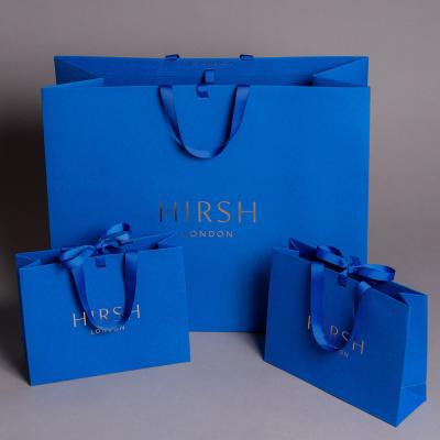 China Silk Rope Handle Peacock Blue Foldable Paper Bag For Clothing Store for sale
