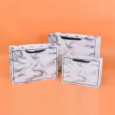China 20*28cm 26*35cm 32*43cm Cosmetic Paper Bags With Ribbon Handles for sale