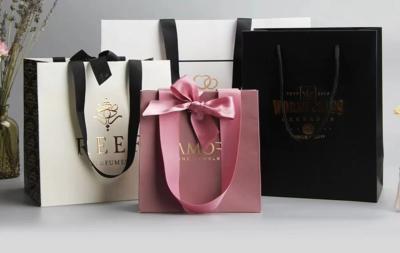 China Apparel Smoky Printed Paper Shopping Bags C2S Artpaper Ribbon Handle Gift Bags for sale