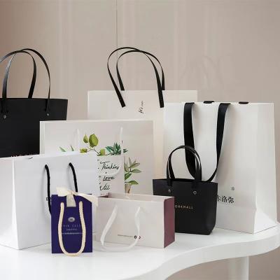 China Kundenspezifische kosmetische Papiertüte-Kleidungs-LuxusEinkaufstaschen mit Griffen zu verkaufen
