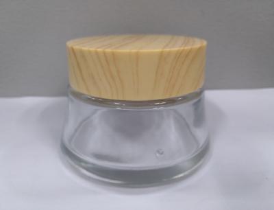 中国 100gガラスのクリームはSkincareの包装のクリームをびん詰めにするさまざまな色を印刷OEM震動させ、 販売のため