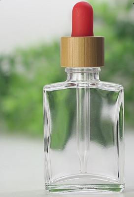 China 30ml Bamboo Cosmetic Packaging Flat Shape Glass Dropper Bottle for sale