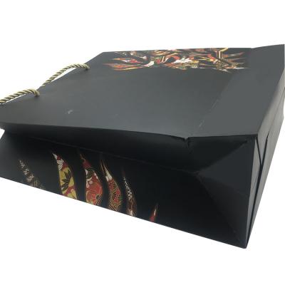 China Ribbon Handle Large Paper Carrier Bags Black Color Paperboard Material for sale