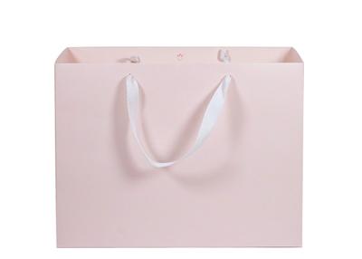 China Eco - Friendly Paper Shopping Bags Pink Color With Twill Cotton Rope Handle for sale