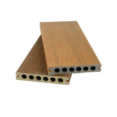 Cina Co Extrusion Wood Plastic Composite Decking Boards  Outside Flooring 138x23mm Round Hole HDPE in vendita