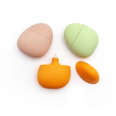 中国 40ml Orange Pink Green Pebble Shape Empty Bottle For Sunscreen Lotion Hand Cream 販売のため