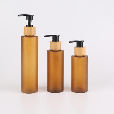 China 120ml 150ml 200ml Amber Plastic Shampoo Bottles With Pump Bamboo Skincare Packaging for sale
