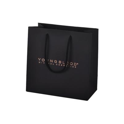China 190gsm Paper Packaging Bags , Black Paper Gift Bags With Custom Gold Foil Stamping for sale