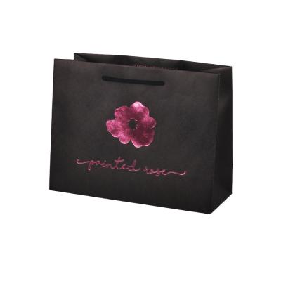 China OEM Paper Packaging Bags , Black Kraft Gift Bags With Purple Foil Stamping for sale