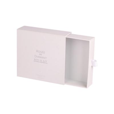 China Caja de regalo de cajón en relieve blanco Embalaje cosmético con mango de cinta en venta
