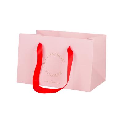 China Biodegradable Pink Stamping Paper Cake Packaging Bags With Ribbon Handle for sale