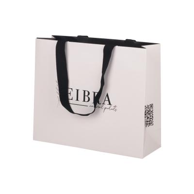 China Eco Friendly White Gift Paper Bags Clothing Packaging With Flat Cotton Handle for sale