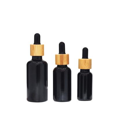 China 15ml 30ml 50ml Black Glass Dropper Vial Bottles With Bamboo Lid ODM for sale
