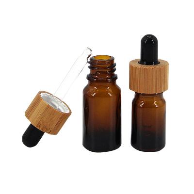 China Empty Hot Stamping 50ml Amber Dropper Bottles With Wooden Head for sale