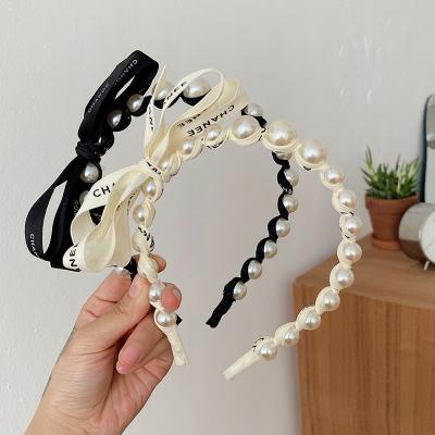 China Pearl Fine alphabet Streamer Wrap Headband With Bow for women en venta